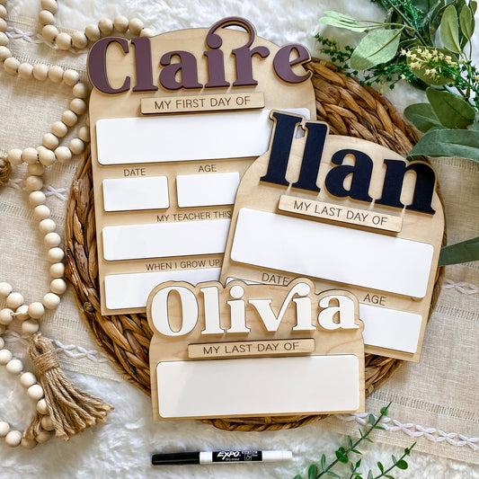 Wooden nameplates with placeholders for 'Claire', 'Ilan', and 'Olivia' on a textured surface with decorative elements.